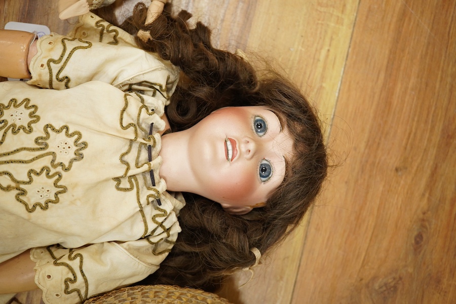 An Al & Cie, Ed Tasson Limoges bisque doll, with fixed glass eyes, open mouth and pierced ears, jointed composition body, a a small French bisque doll, stamped SG, and a German painted bisque doll, Limoges 54cm. Conditio